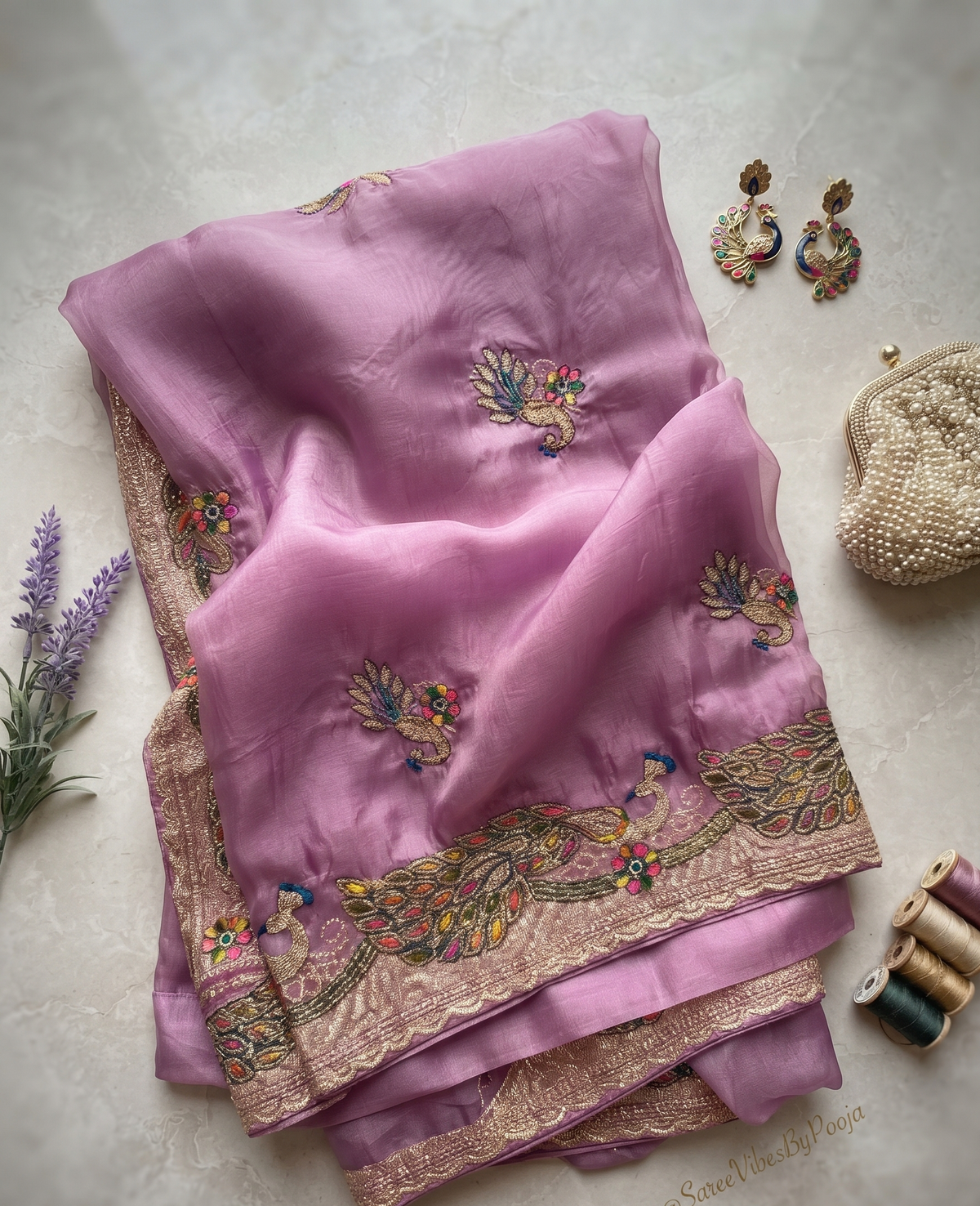 Lavender saree with colourful peacock embroidery and gold-tone border