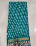 Teal saree with diagonal stripes and colourful floral border